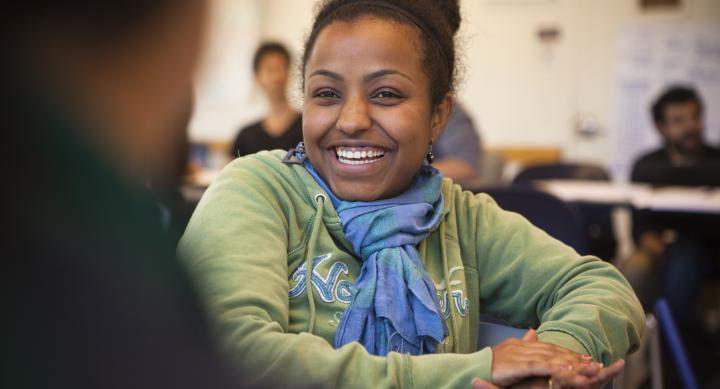 Woman in a green sweater smiles